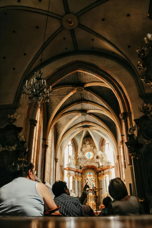 a church with a lot of people sitting on benches