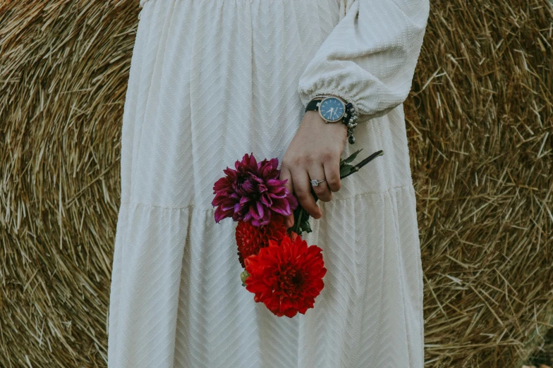 a woman holding flowers on her right hand