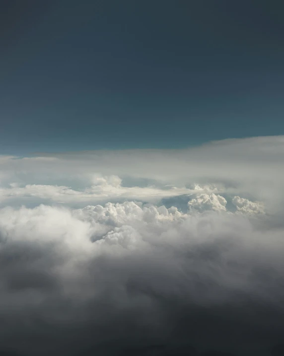 the airplane is flying above the clouds together