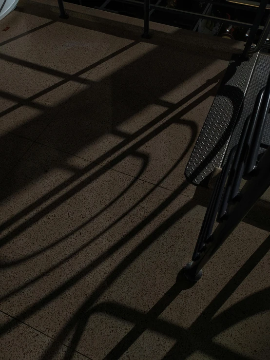 two chairs sitting on top of a floor next to a metal railing