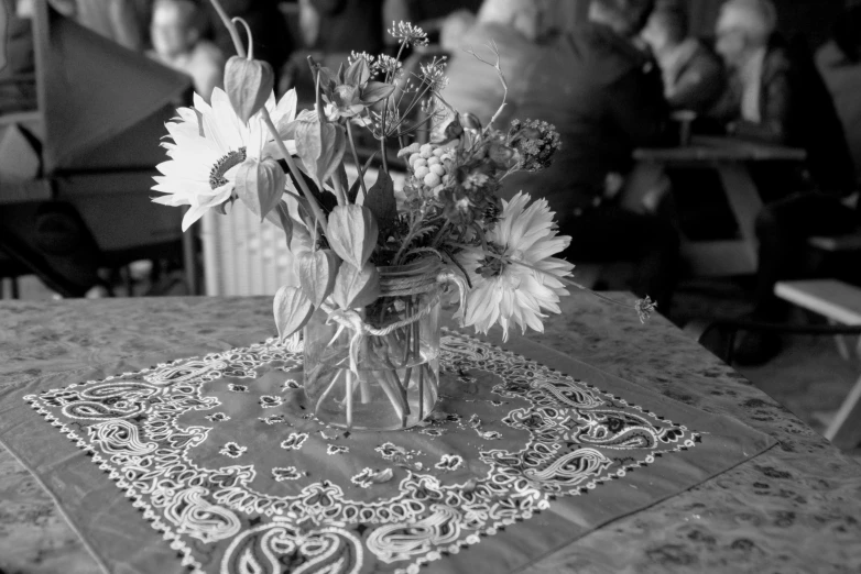 the table cloth is holding a bouquet of flowers