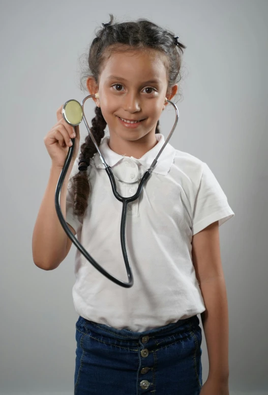 a girl is holding a stethoscope and making a weird face