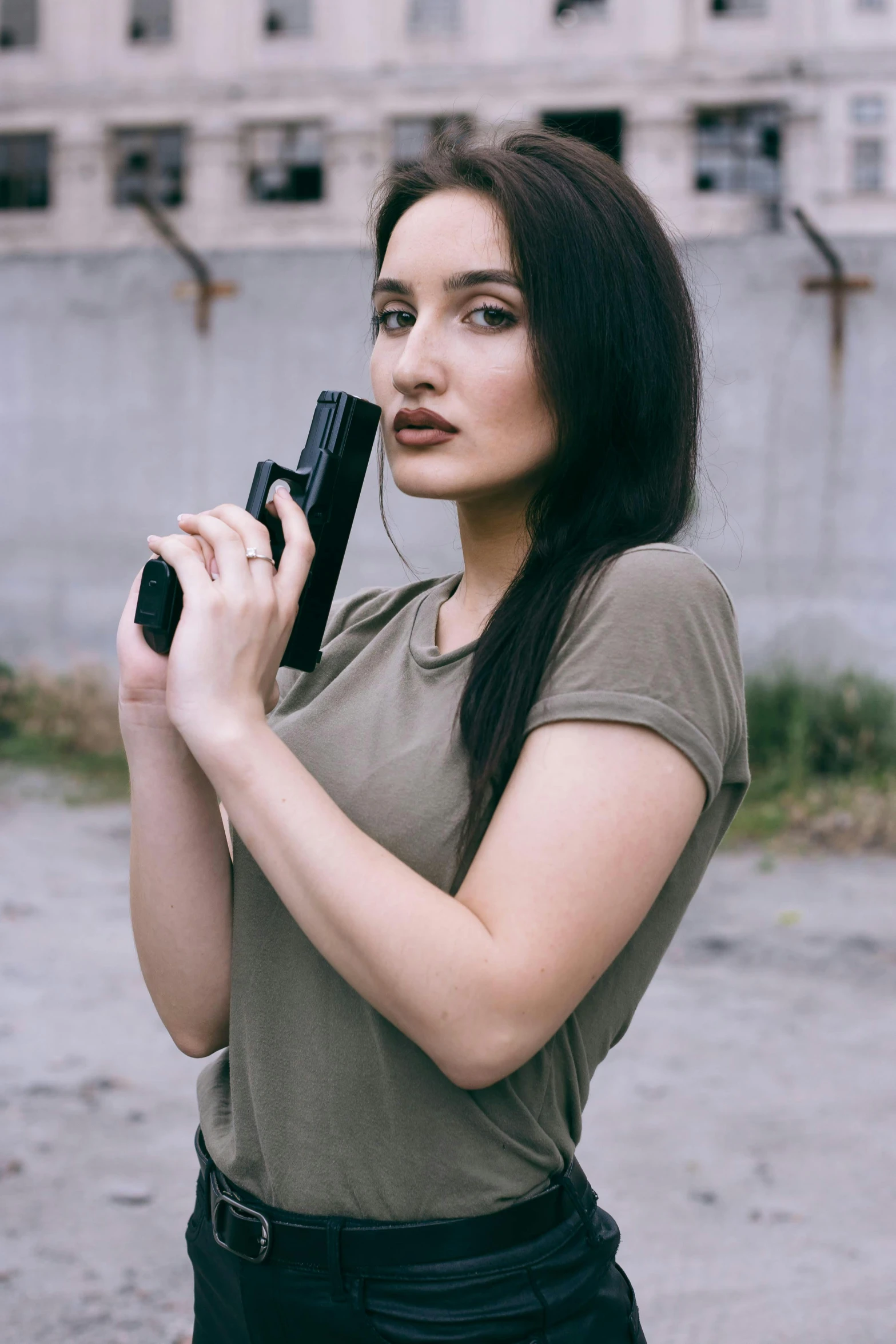 a girl is holding a radio outside