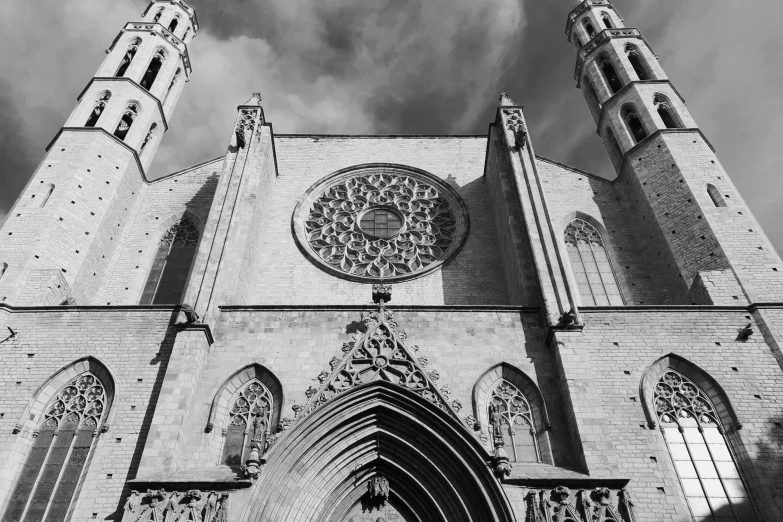 a large church building with two steeples and a clock on it