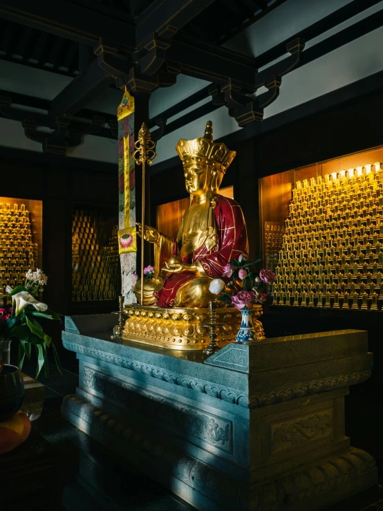 the buddha statue has flowers on top of it