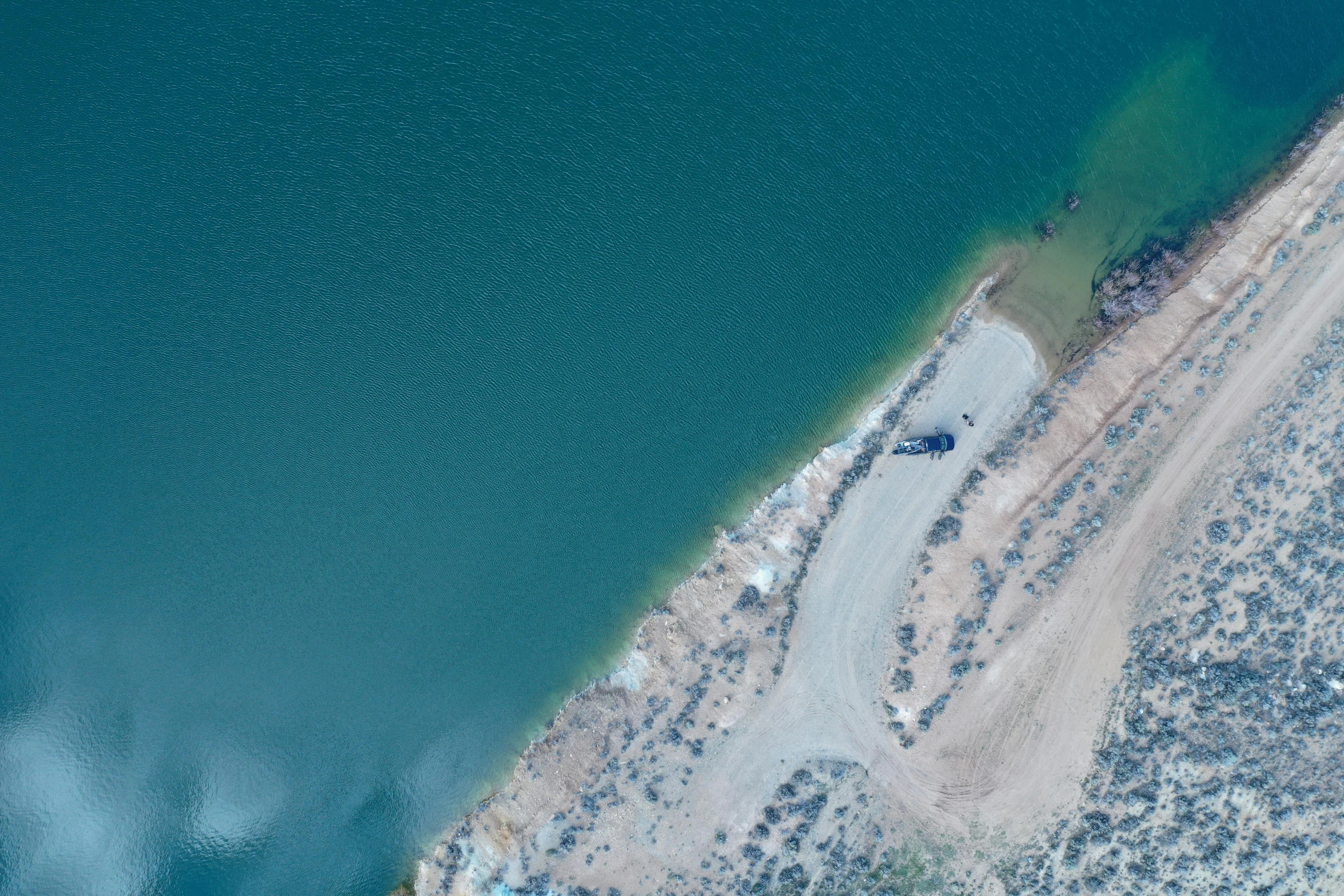 an aerial view of a beach surrounded by water