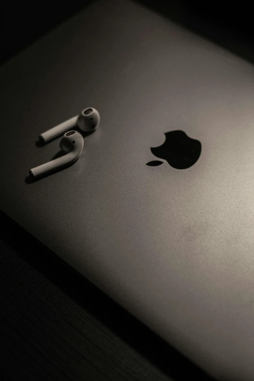 apple products sitting next to each other on a dark surface