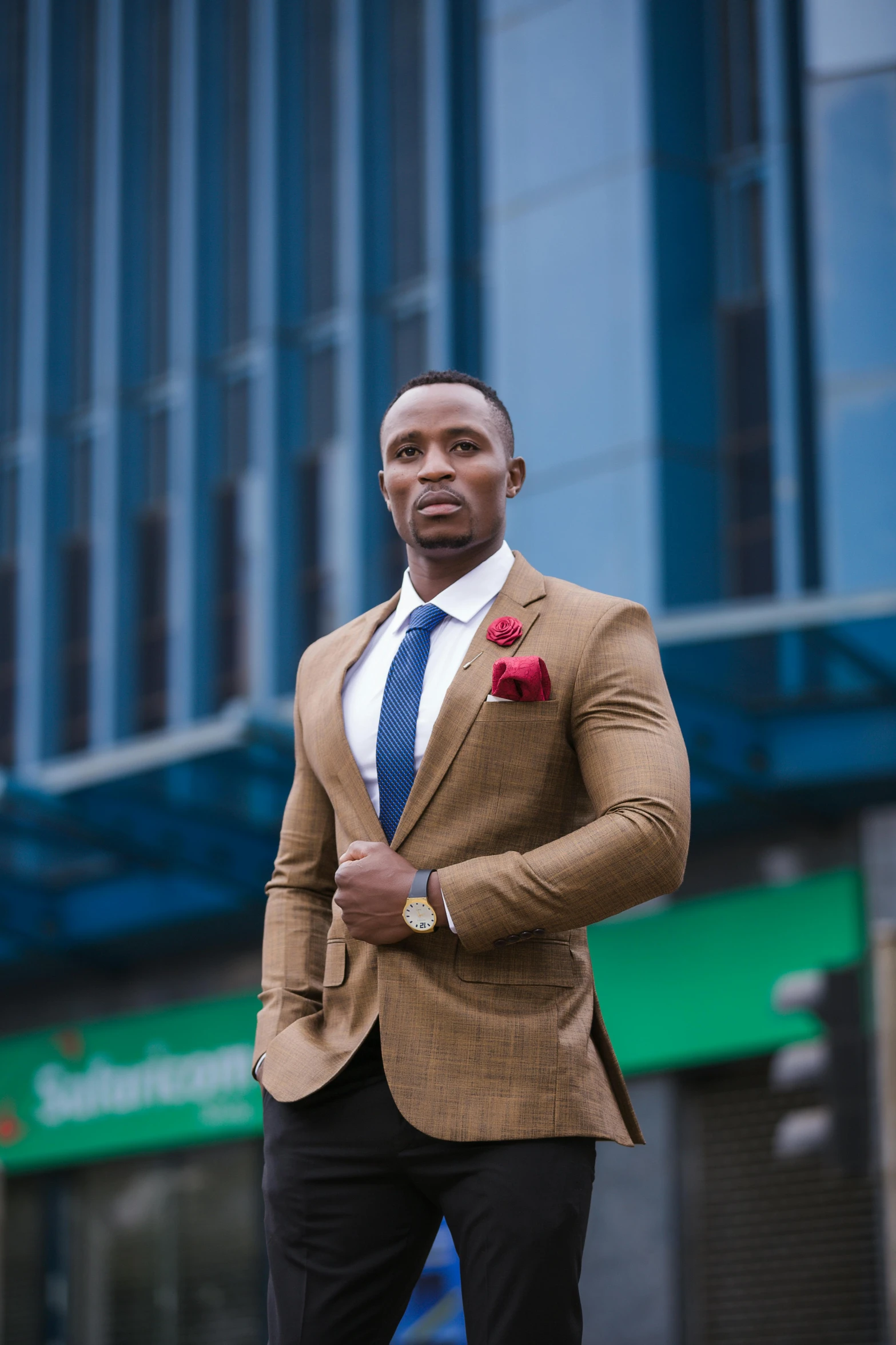 the man in the suit has a red flower in his lapel