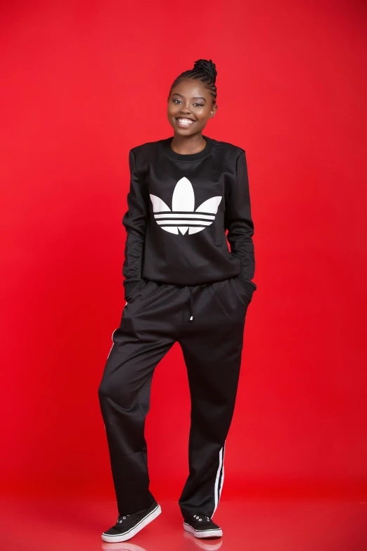 a black woman with an adidas sweatshirt and pants