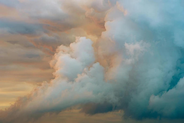 clouds that are coming up over land on a cloudy day