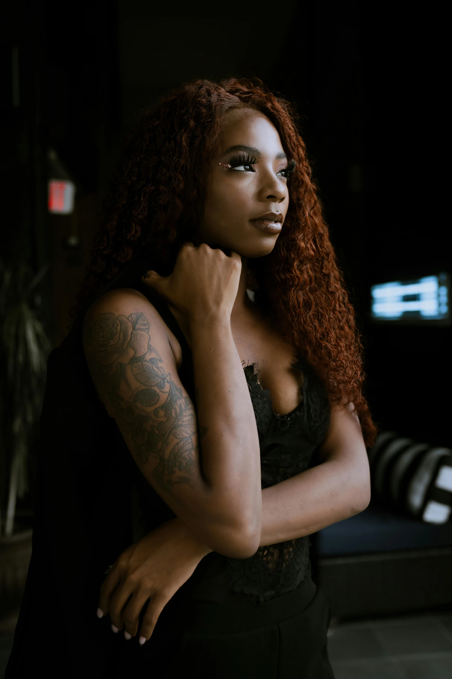 a woman with long red hair wearing black clothes