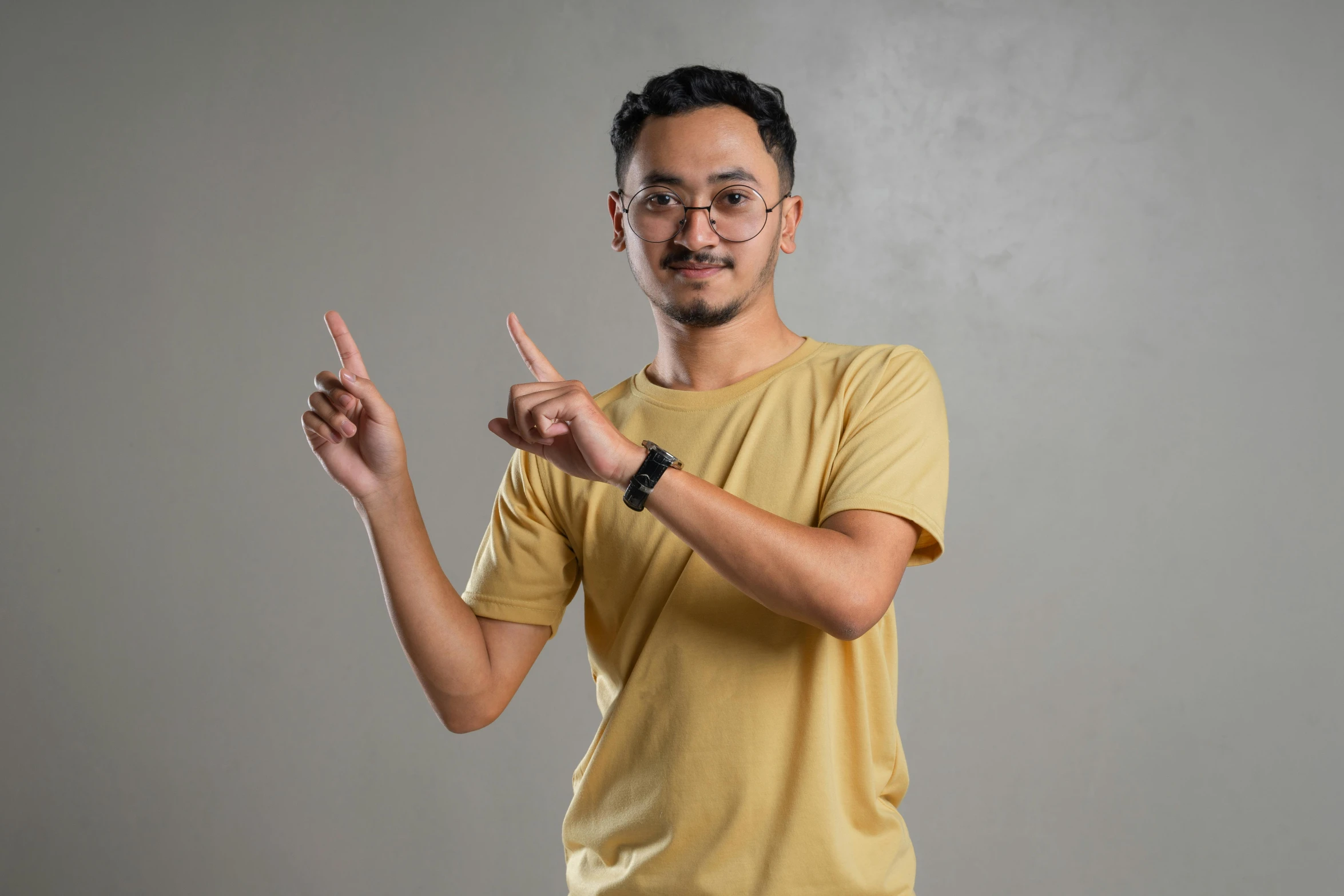 a man wearing glasses holding out his hand