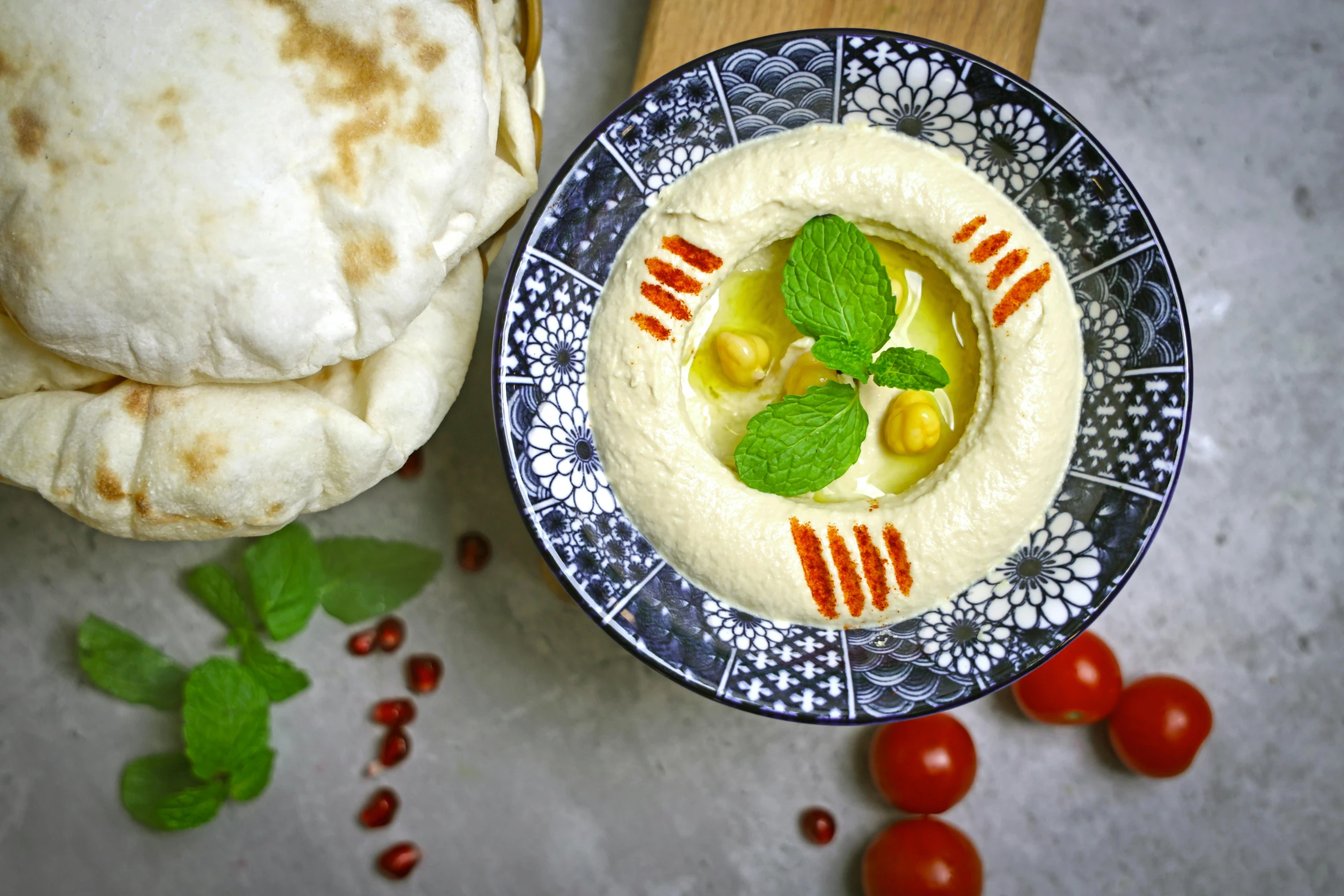 a hummus with fresh mint garnish in it