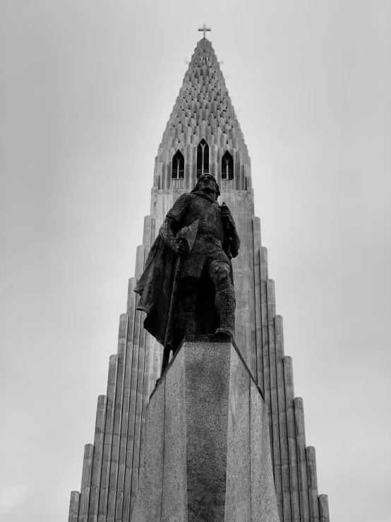 a large tower with a statue on it's side