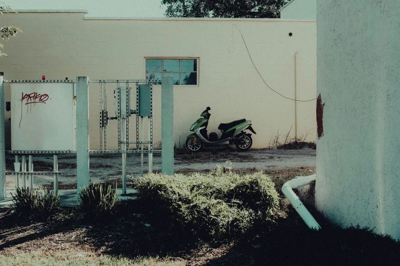 a motorcycle parked next to a house and a tree