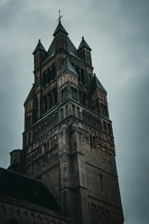 tall clock tower on cloudy day with dark clouds