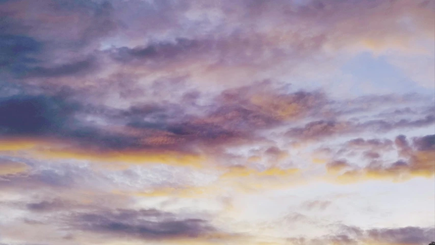 a colorful sunset with dark clouds and purple clouds