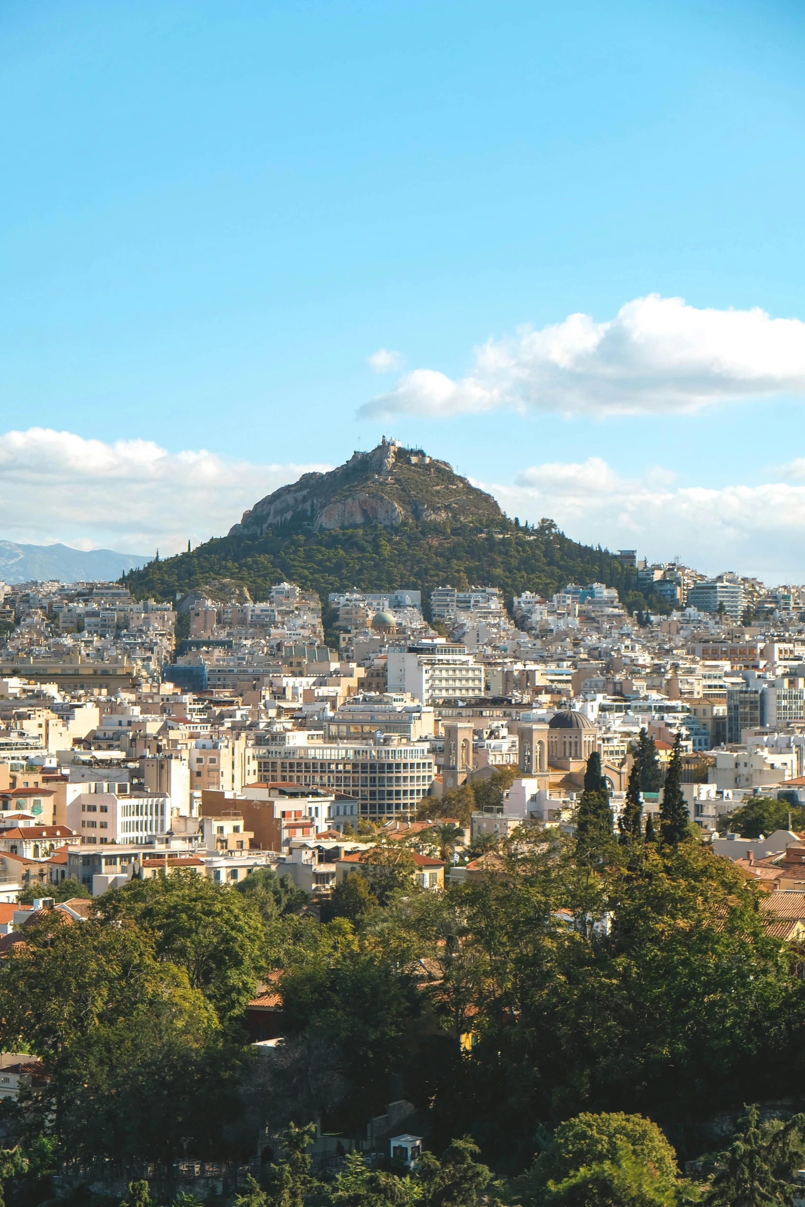 a large city with hills in the back ground