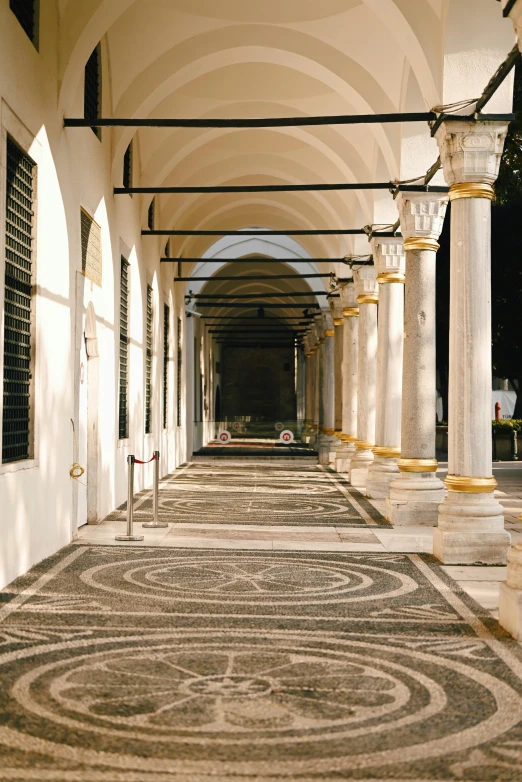 a row of white buildings on both sides of an arcade