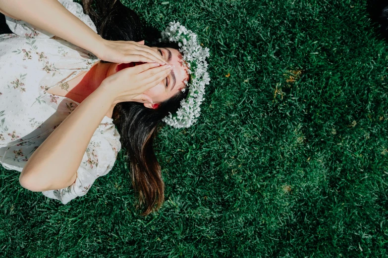 a person in white dress and red lips standing on grass