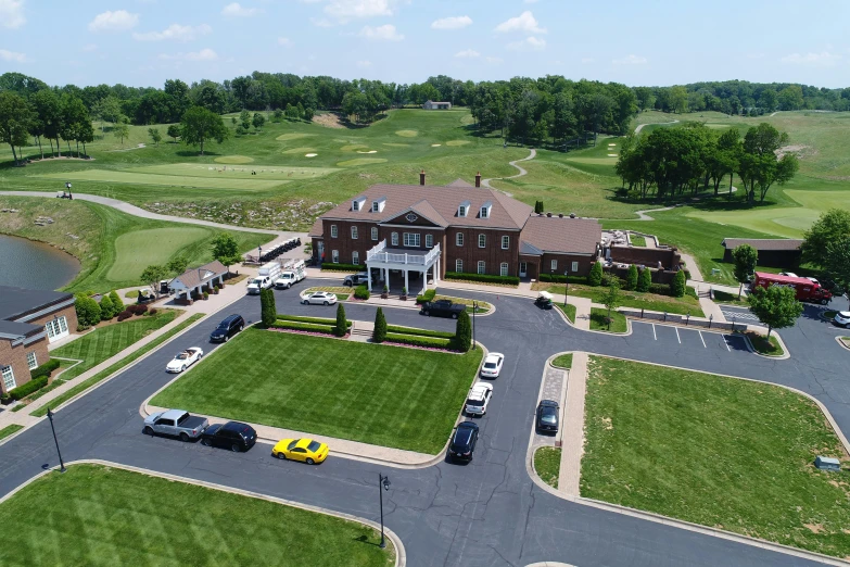 the large mansion is surrounded by beautiful green spaces