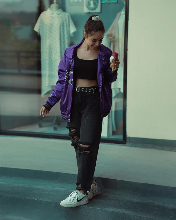 woman with bag and ripped black leggings walking down the street