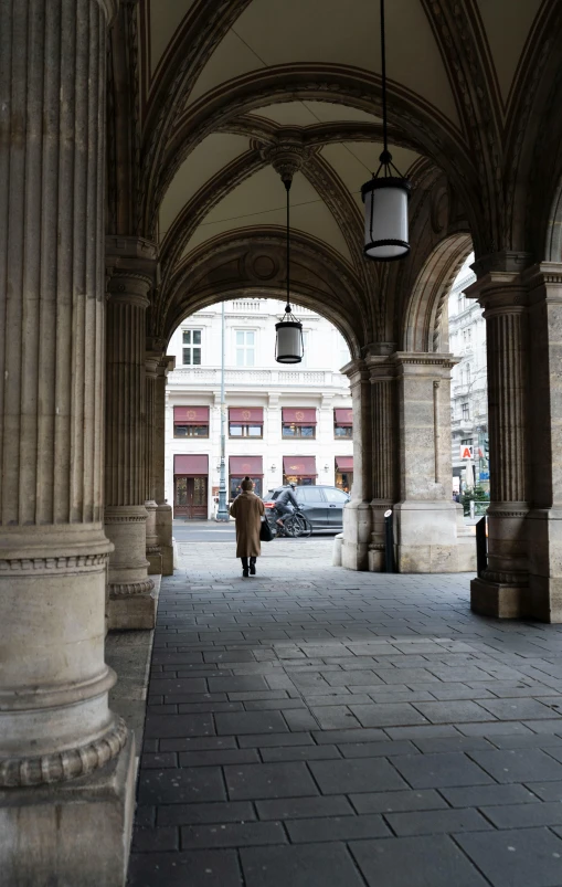 a person walking down a brick covered sidewalk