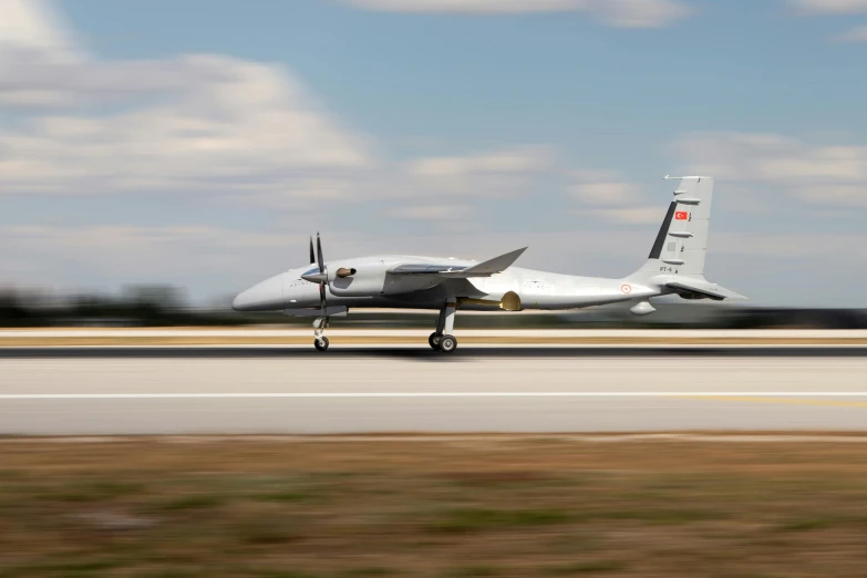 a plane with wheels on the wing is seen taking off