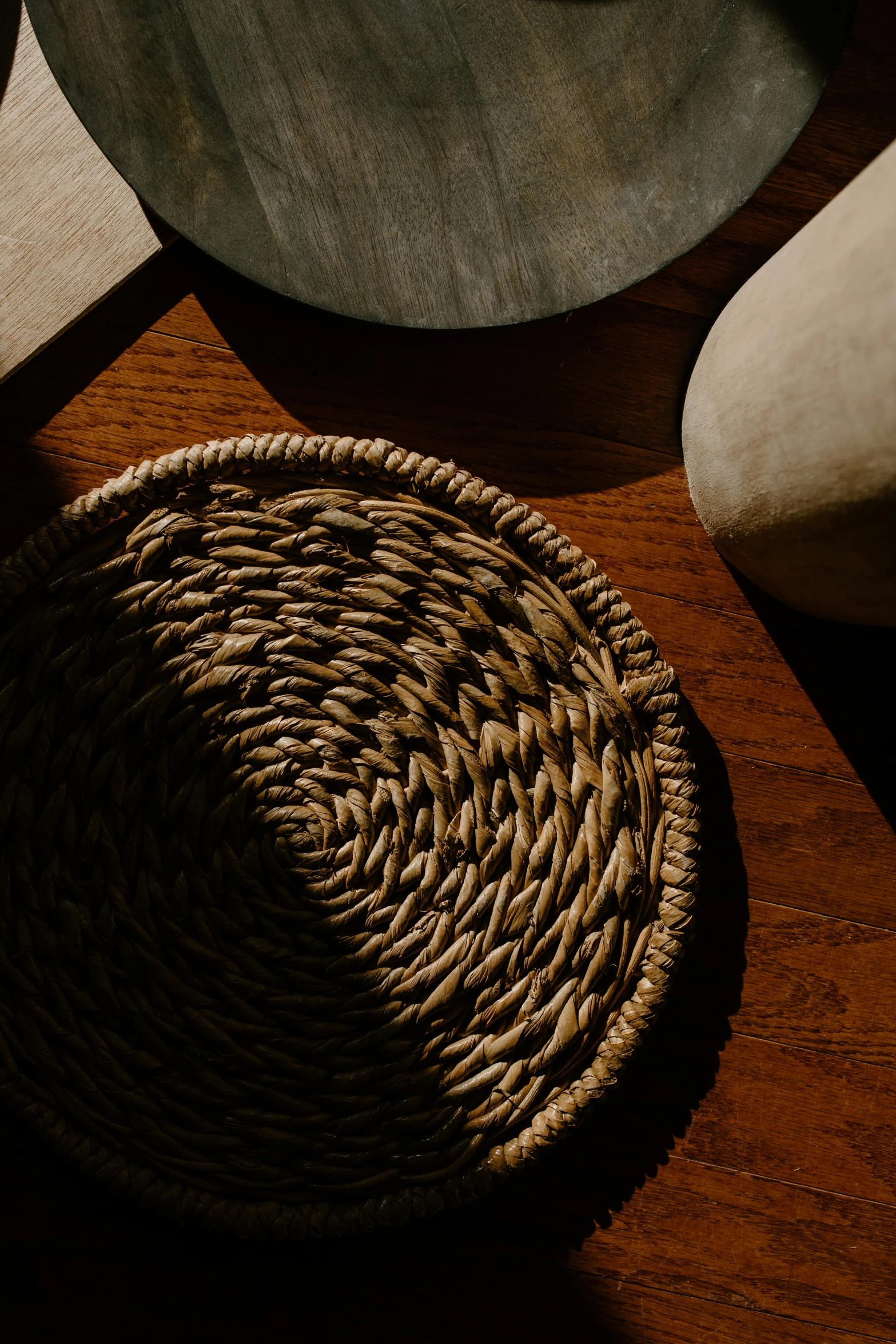 a basket sitting on a wooden table next to a rock