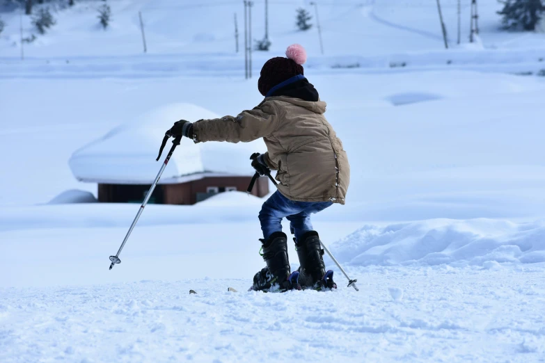 a person riding skis and walking on snow covered ground