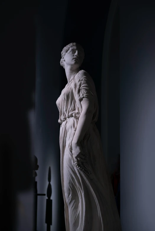 statue of young woman with large long dress in room