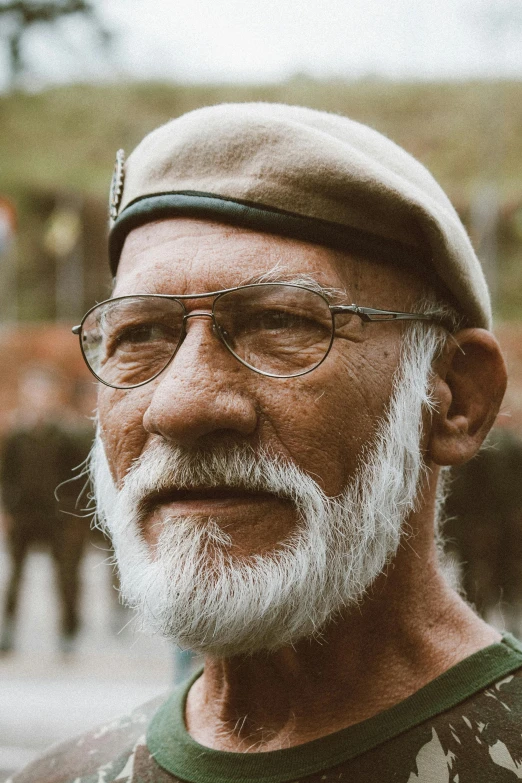 a man with a beard and glasses is standing