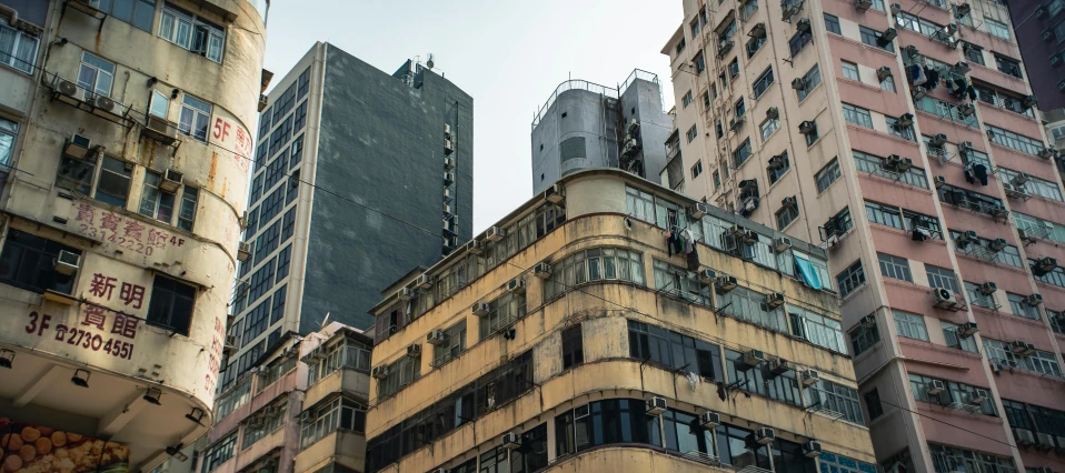 many tall buildings on the corner of a street