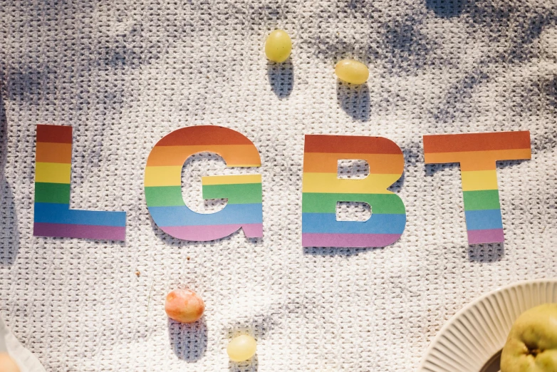 a rainbow text made out of different colored plastic eggs and the word lgbt spelled in large letter to spell out a colorful object for the viewer