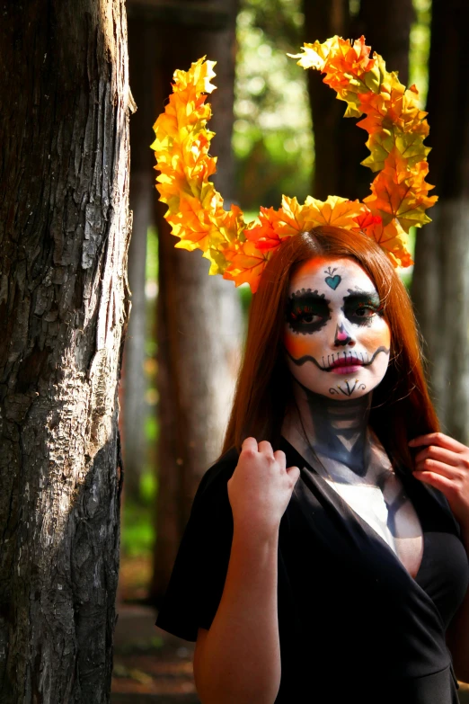 the woman is wearing a scary make up in the forest