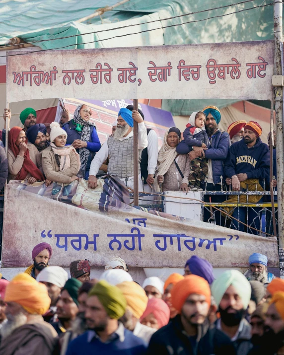 a group of people standing in front of a banner