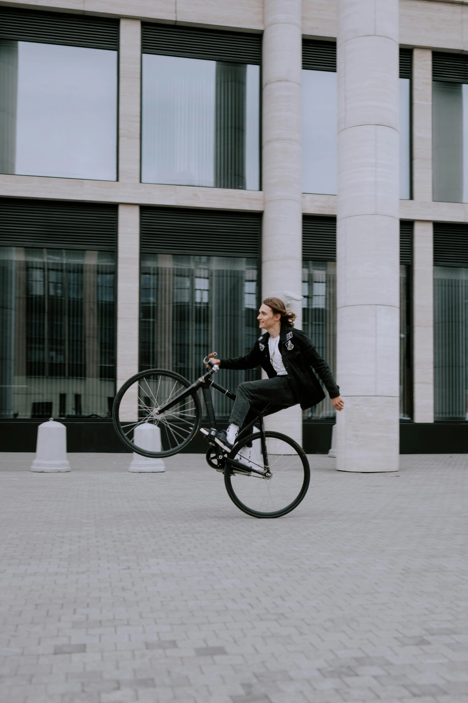 a woman riding a bicycle in front of a building