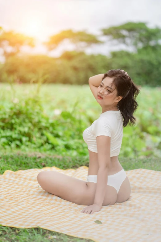 a woman is sitting on the grass