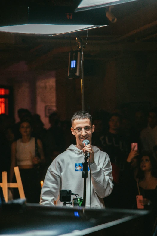 a man standing next to a microphone and holding a microphone