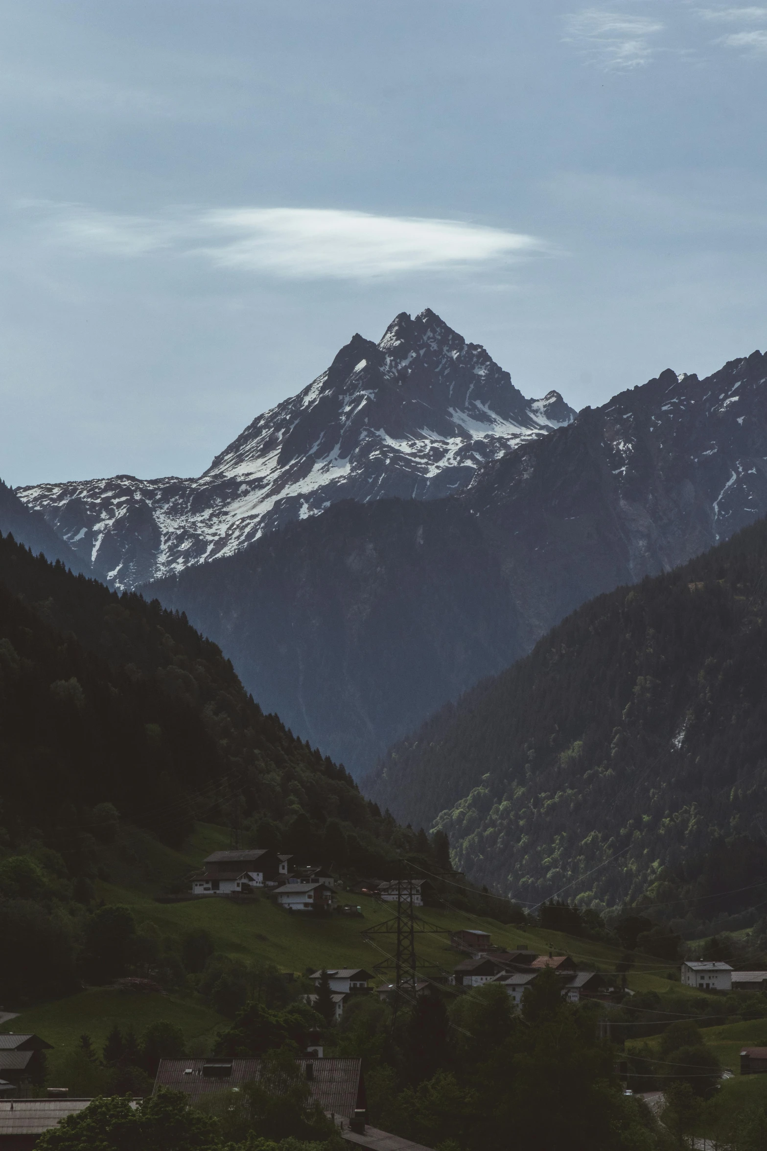 the mountains are covered in snow and green