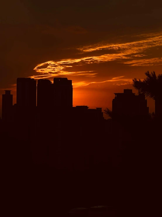 a very beautiful sunset view over some tall buildings