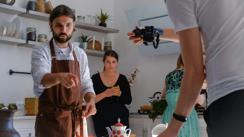 several people are preparing food in the kitchen