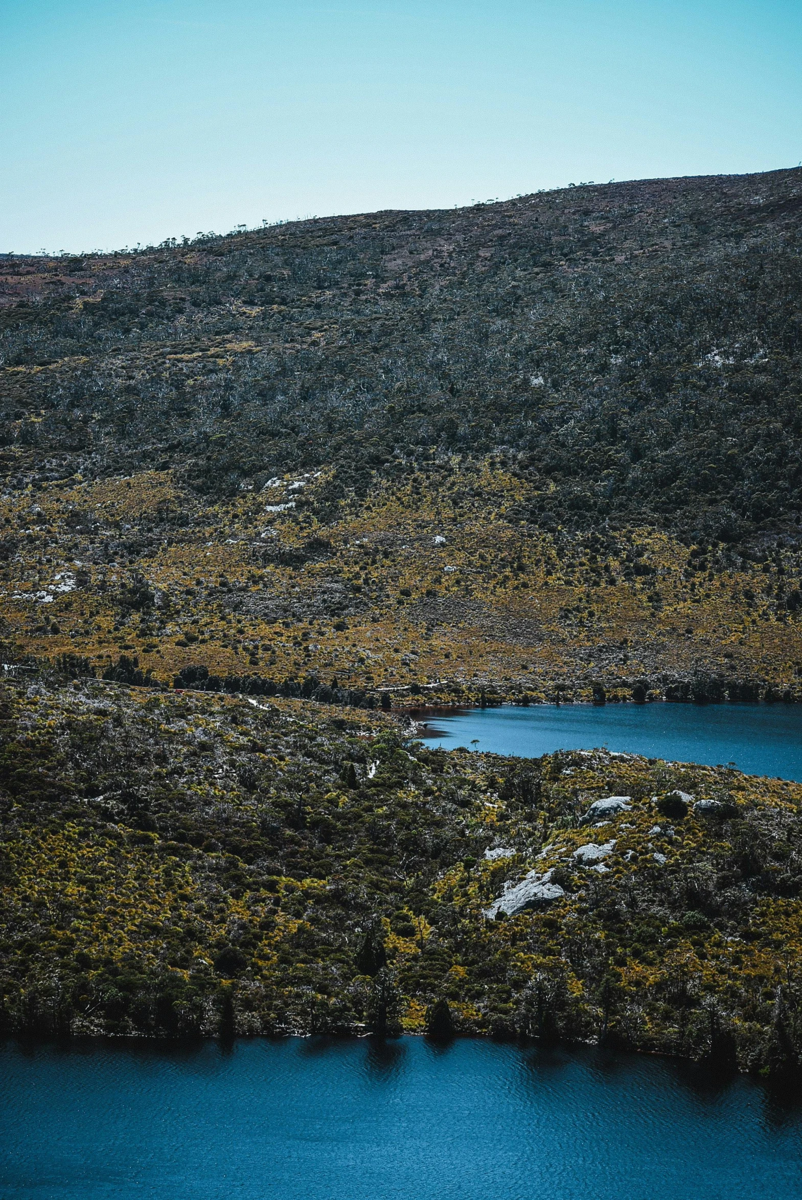 the mountain side has blue water on it