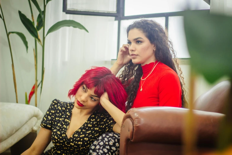 two beautiful women with red hair and red lipstick