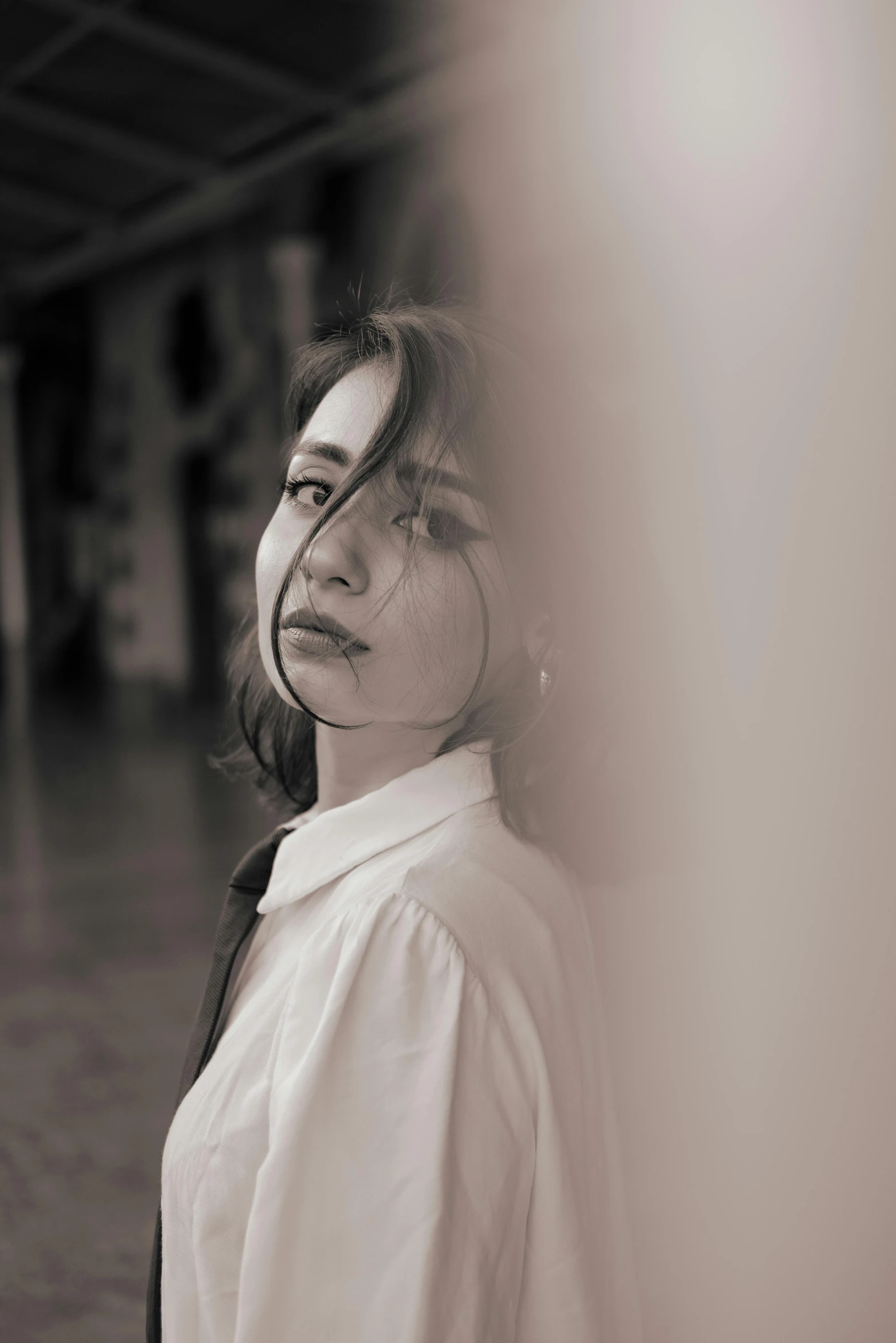 woman leaning against the wall in an empty building