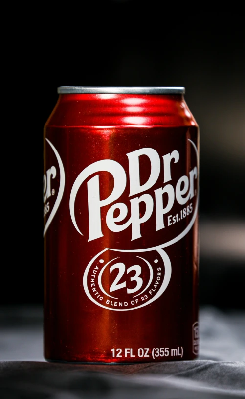 a red soda can that is on a table