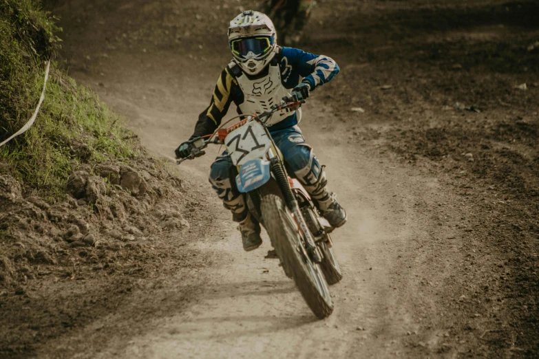 a person is riding a dirt bike on a muddy track