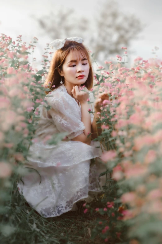 an asian lady in a field of wildflowers