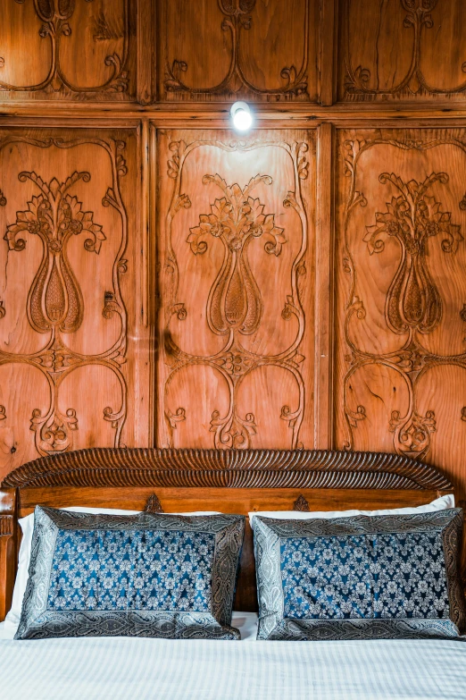 a made bed in a room with wood paneling