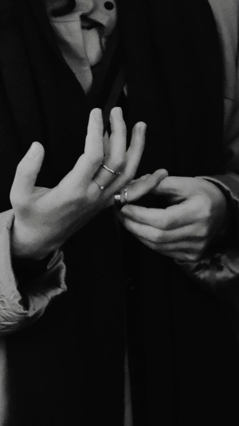 a couple holding hands with their fingers